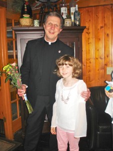 Stacy, a recent First Communicant, gave Fr. Bob Koszarek a bouquet of flowers May 18 at his retirement/anniversary party at Eagle Waters Resort. Daniszewski’s family is Polish; she is bilingual and “a very devout child,” the priest said. (Submitted photo)