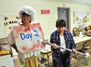 Vacation Bible school teachers Maureen Hendricks, left, and Cathy Ney, right, play with props Thursday, July 9, at St. Mary, Minong. Both professional educators, the women are on a mission to teach students about stewardship. “I sort of feel like that’s what we’re doing – it’s a mission,” Ney said. “That’s a huge part of our community – outreach. Reaching out to others.” (Catholic Herald photo by Anita Draper)